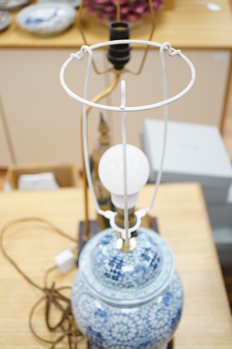 A Chinese blue and white ‘shuangxi’ vase and cover, mounted as a lamp, together with a lamp mounted with a bronze Thai figure, largest 50cm high including light fitting